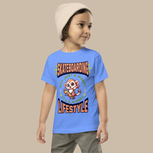 Toddler tee design featuring a cartoon tarsier riding a skateboard with the text “Skateboarding – Not Just a Hobby, It’s a Wheel Lifestyle,” celebrating fun, movement, and Filipino culture.