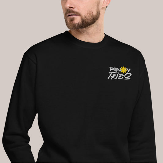 PINOY TRIBO™ logo with bold white text and the iconic yellow Philippine sun, embroidered on a cozy ultra-soft crewneck sweatshirt, perfect for showcasing Filipino pride.