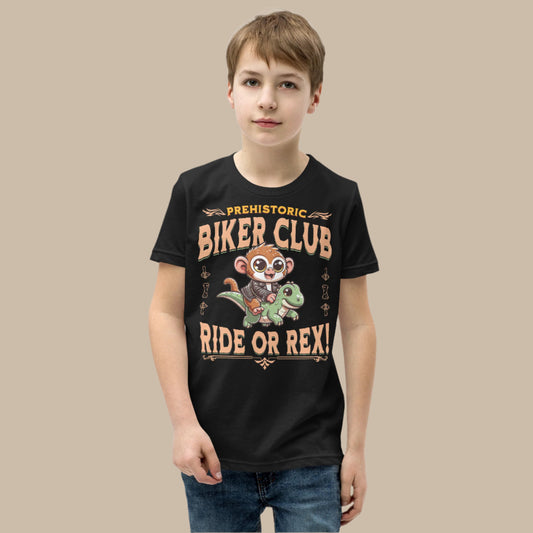 Cute cartoon Philippine tarsier in a biker jacket riding a green dinosaur with “Prehistoric Biker Club” and “Ride or Rex!” text on a youth t-shirt design.