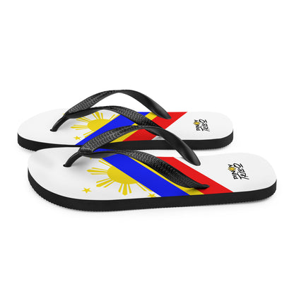 Flip flops featuring a bold Philippine flag-inspired design with diagonal blue, red, and yellow stripes, black straps, and the PINOY TRIBO™ logo printed at the heel.