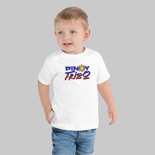 T-shirt featuring the PINOY TRIBO™ tri-color logo with bold blue and red script and a sun icon representing the Philippine flag.