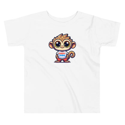 Toddler tee design featuring a cartoon tarsier character wearing a shirt with the words “Pinoy Tribo” in red and blue text, celebrating Filipino identity and youth style.