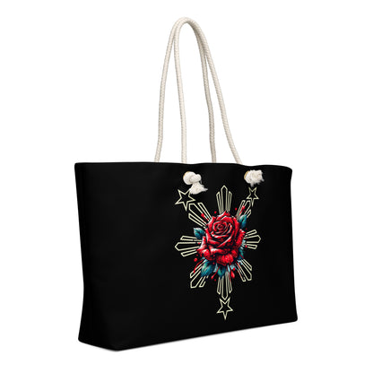 Weekender bag with a rose and sunburst three-star Filipino design on a black background with rope handles.