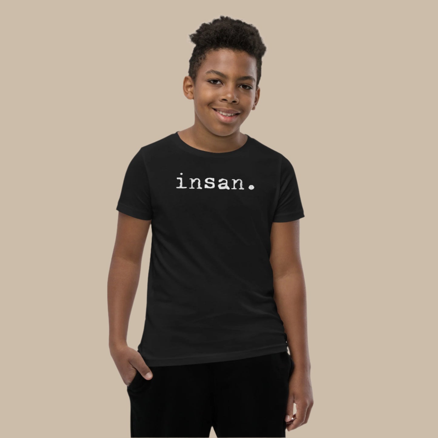 Minimalist white text “insan.” in a typewriter-style font on a youth t-shirt design.