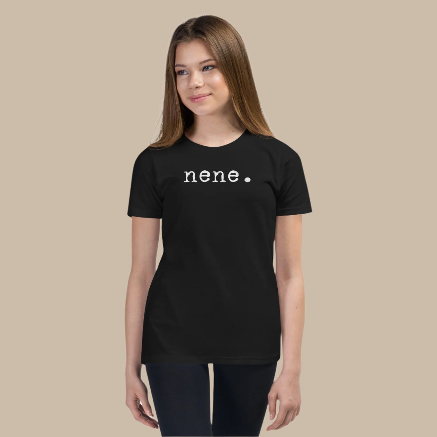 Minimalist white text “nene.” in a typewriter-style font on a youth t-shirt design.