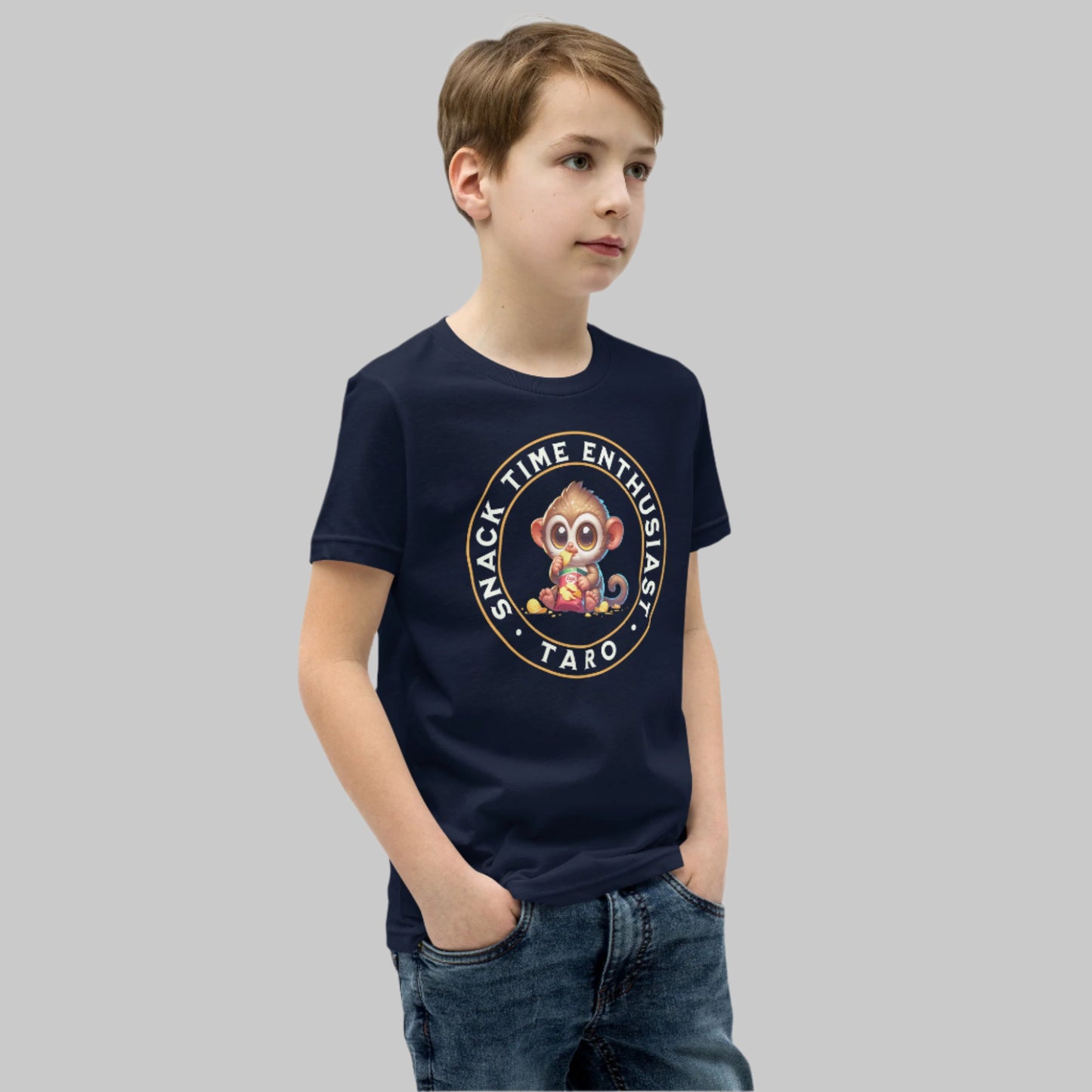 Cute cartoon Philippine tarsier named Taro eating chips with “Snack Time Enthusiast” text in a circular badge on a youth t-shirt design.